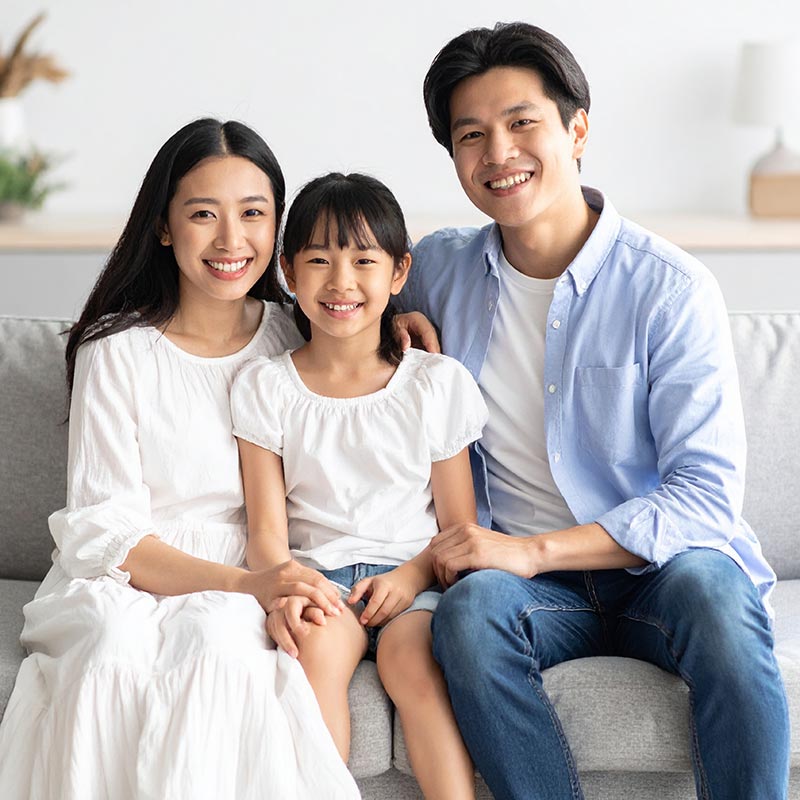 SPED Smiling family sitting on couch