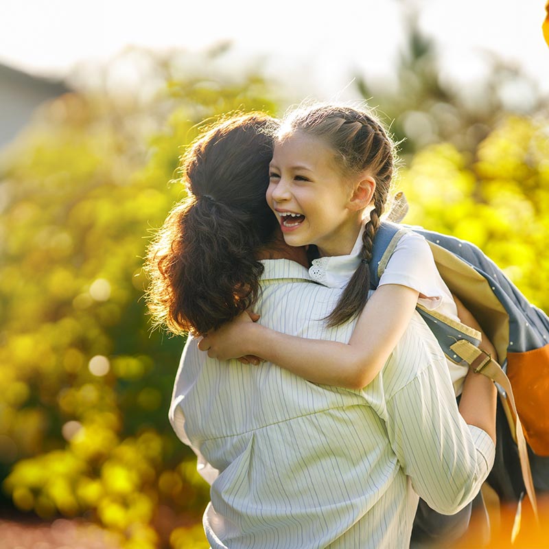 image of mother holding smiling girl